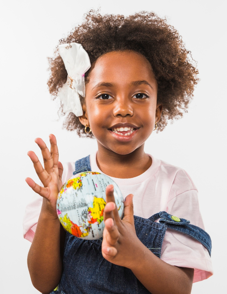 Smiling student holding a globe